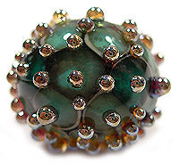 Load image into Gallery viewer, Example of Iris Gold Frit dots on a bead by Glass Diversions
